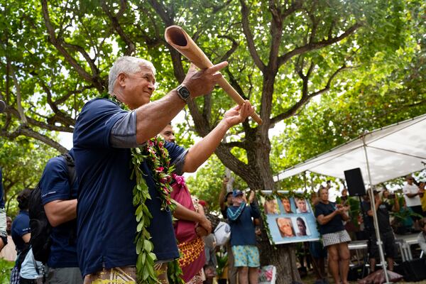 Bruce Blankenfeld, the leader of Polynesian Voyaging Society, receives an offering during Hokulea's 50th birthday commemoration at Kualoa Regional Park, Saturday, March 8, 2025, in Kaneohe, Hawaii. (AP Photo/Mengshin Lin)