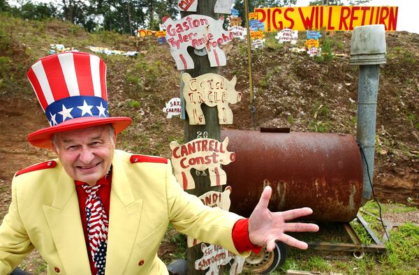 Oscar Poole, owner of Col. Poole's Bar-B-Q in Ellijay, stands outside his Ellijay eatery in 2003. / AJC file photo