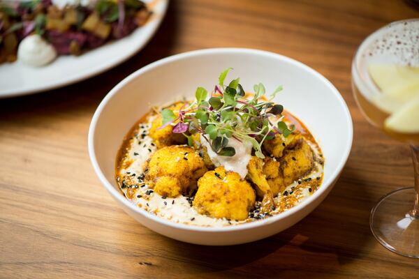 Cauliflower Shawarma with hummus, raita, sesame seeds and pita. Photo credit- Mia Yakel.