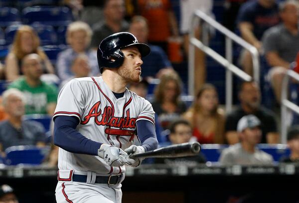 Freddie Freeman watches his first-inning home run Saturday night. He hit another in the fifth inning. (AP Photo/Wilfredo Lee) 