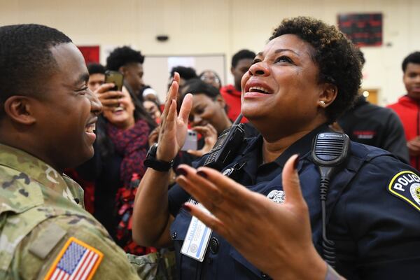 Atlanta Public Schools police officer L.J. Williamson is surprised by her son, U.S. Army Specialist Shakir Aquil, who is home for the first time in two years. The reunion took place during a pep rally at Therrell High School on Friday, Jan. 17, 2020, in Atlanta. JOHN AMIS