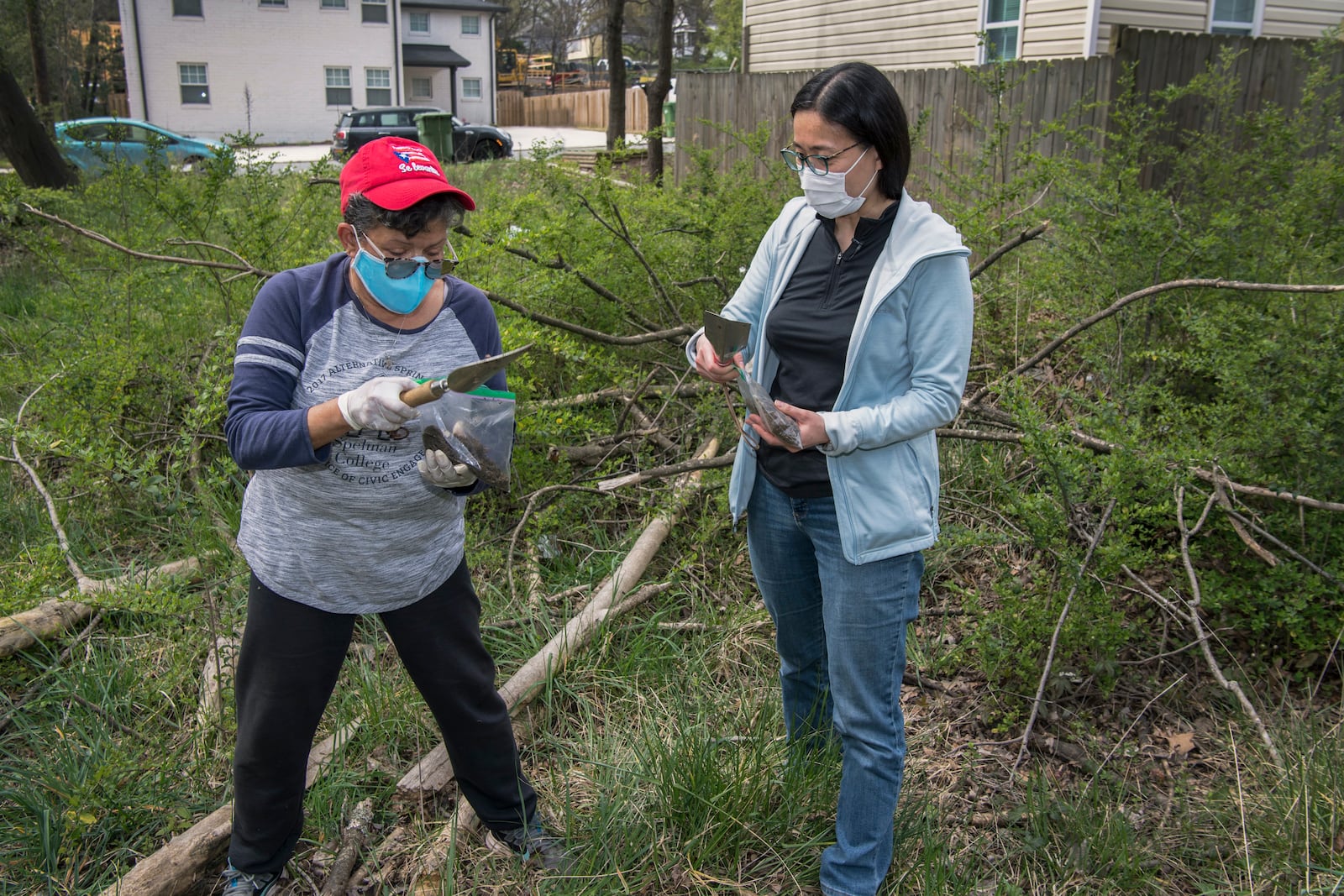 Rosario Hernandez (left), Historic Westside Gardens member and a Westside resident, works alongside Eri Saikawa, associate professor of Environmental Sciences at Emory University, gathering soil samples for testing in the neighborhood.