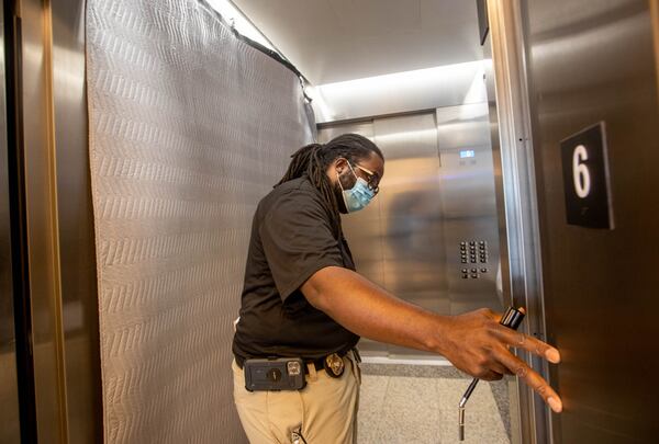 Inspector Kenny Leatham works on the annual inspection of elevators at the Nathan Deal Judicial Center on Wednesday. The state regulations for elevator safety, enforced by the Georgia Department of Insurance and Safety Fire, span 32 dense pages and cover everything from freight elevators to hand-powered lifts to chairlifts mounted in staircases. (Jenni Girtman for The Atlanta Journal-Constitution)