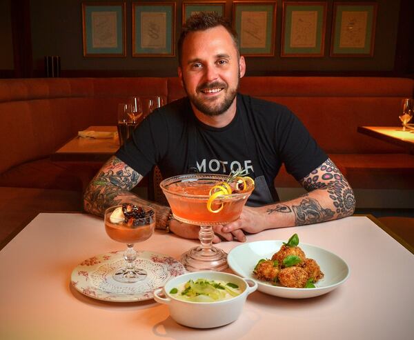 Jeb Aldrich, executive chef at Tiny Lou’s, shared some recipes for a New Year’s Eve dinner: Dark Chocolate Champagne Pot de Crème with Vanilla Chantilly and Macerated Blackberries (left), New England Shellfish Chowder (front center), Cranberry Countdown Punch (rear center) and Crab Beignets (right). STYLING BY JEB ALDRICH / CONTRIBUTED BY CHRIS HUNT PHOTOGRAPHY