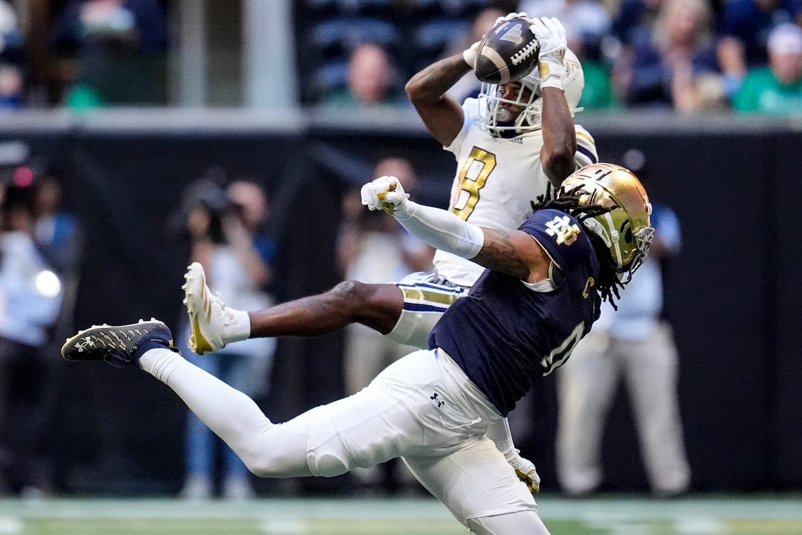 Georgia Tech wide receiver Malik Rutherford (8) makes the catch against Notre Dame safety Xavier Watts (0) during the first half of an NCAA college football game, Saturday, Oct. 19, 2024, in Atlanta. (AP Photo/Mike Stewart)