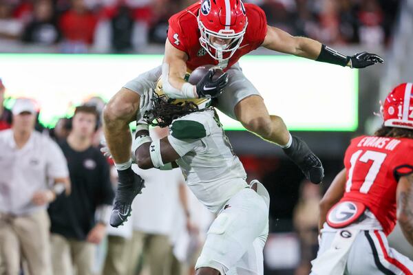 Georgia tight end Oscar Delp (4) tries to leap over the tackle of UAB safety Keondre Swoopes (0) during the fourth quarter against UAB at Sanford Stadium, Saturday, September 23, 2023, in Athens, Ga. Georgia won 49-21. (Jason Getz / Jason.Getz@ajc.com)