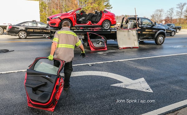 Cobb County fire crews that responded to the accident had to cut off the top of the car to free the driver. JOHN SPINK / JSPINK@AJC.COM