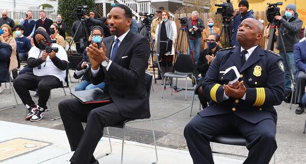 Atlanta Mayor Andre Dickens and Atlanta police Chief Rodney Bryant applaud speakers at the ribbon cutting for a new apartment complex for Atlanta police recruits on Wednesday, Feb. 2, 2022, in Atlanta. (Curtis Compton / Curtis.Compton@ajc.com)