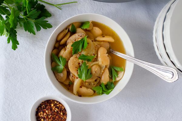 Lima Bean Soup can be topped with items such as red pepper flakes and whole parsley leaves. (Virginia Willis for The Atlanta Journal-Constitution)