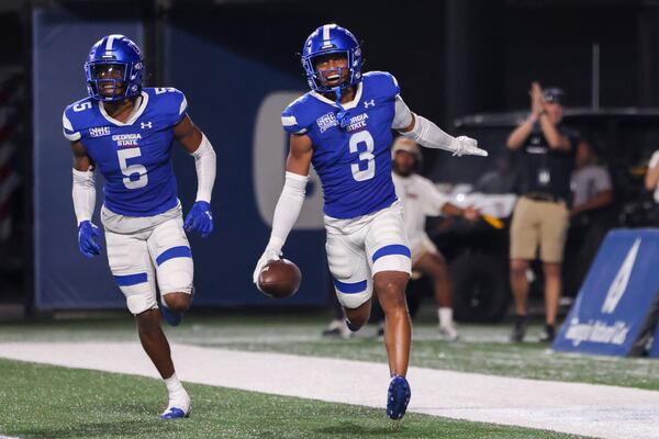 Georgia State defensive back Gavin Pringle (3) celebrates his interception he returned 21 yards for a touchdown during the second half against Rhode Island at Center Parc Stadium, Thursday, August 31, 2023, in Atlanta. Also pictured is Georgia State cornerback Bryquice Brown (5). Georgia State won 42-35. (Jason Getz / Jason.Getz@ajc.com)