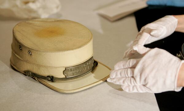 Mary Ballard, a senior textile conservator from the Smithsonian Museum Conservations Institute, examines a Pullman railroad porter hat dating from the 1930s that belonged to the father of a friend of Patricia Heaston at the Harold Washington Library in Chicago, Saturday, Jan. 19, 2008. Librarians from the Chicago Public Library and experts from the Smithsonian's National Museum of African American History and Culture examined the historical items from more than 130 individuals as part of a program called "Save our African American Treasures." (AP Photo/Brian Kersey)