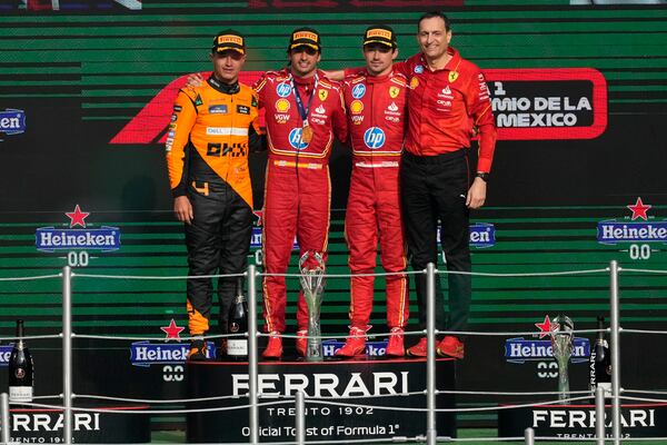 McLaren driver Lando Norris of Britain, second place, Ferrari driver Carlos Sainz of Spain, first place, Ferrari driver Charles Leclerc of Monaco, third place, and Riccardo Adami of Ferrari at the podium on the podium for the Formula One Mexico Grand Prix auto race at the Hermanos Rodriguez racetrack in Mexico City, Sunday, Oct. 27, 2024. (AP Photo/Eduardo Verdugo)