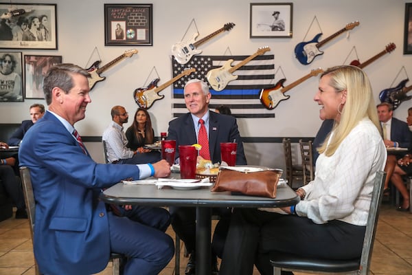 Eschewing face masks, Gov. Brian Kemp eats lunch with his wife,Marty, and then-Vice President Mike Pence at Star Cafe in Atlanta in May 2020. Kemp had allowed restaurants to resume dining-room service the previous month. (JOHN SPINK/JSPINK@AJC.COM)


