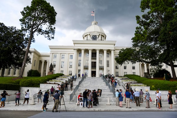 People wait in line to view the body of Congressman John Lewis in the Alabama Capitol Sunday, July 26, 2020, in Montgomery, Ala.  The congressman from Georgia and civil rights icon died July 17 at age 80 after a battle with pancreatic cancer. (AP Photo/Julie Bennett)