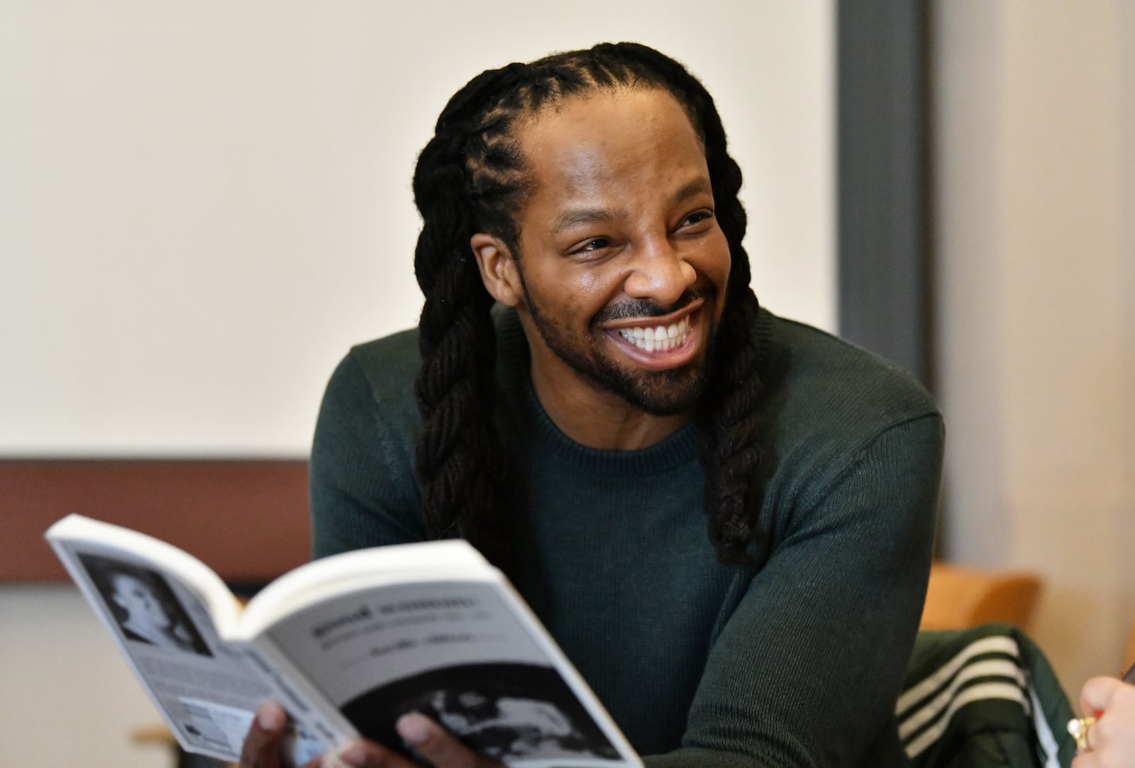 Jericho Brown, Charles Howard Candler Professor of English and Creative Writing, reads a poem as he teaches his class at Emory University, Tuesday, February 6, 2024, in Atlanta. Jericho Brown is one of contemporary literature’s most acclaimed poets. In 2019, his third book, “The Tradition”, won him the 2020 Pulitzer Prize for Poetry. Along with the Pulitzer, he has won a Whiting Award, a Guggenheim Fellowship, an American Book Award and was the inaugural winner of the Anisfield-Wolf Book Award for poetry. (Hyosub Shin / Hyosub.Shin@ajc.com)