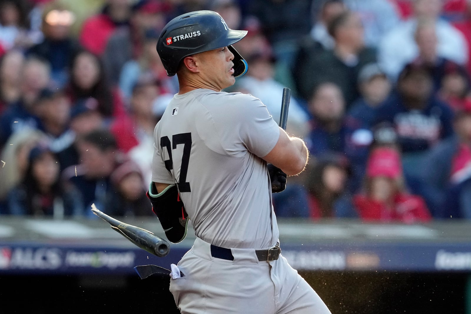 New York Yankees' Giancarlo Stanton breaks his bat hitting a ground out against the Cleveland Guardians during the third inning in Game 3 of the baseball AL Championship Series Thursday, Oct. 17, 2024, in Cleveland.(AP Photo/Godofredo Vásquez )