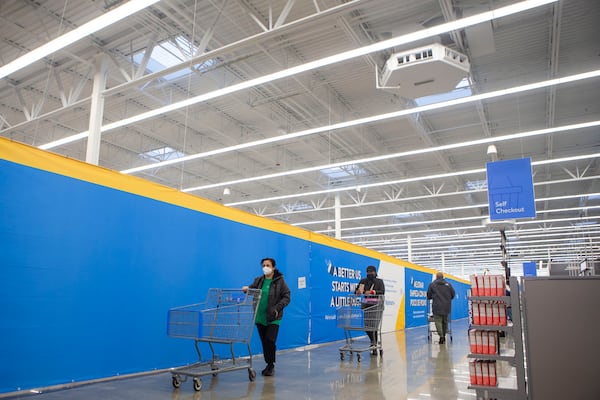 Walmart customers shop during the re-opening of Walmart in Peachtree City, Georgia, on Wednesday, December 21, 2022. The store reopened after burning down in August 2022. CHRISTINA MATACOTTA FOR THE ATLANTA JOURNAL-CONSTITUTION.