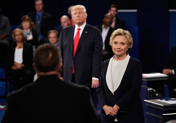 ST LOUIS, MO - OCTOBER 09: Democratic presidential nominee former Secretary of State Hillary Clinton (R) and Republican presidential nominee Donald Trump listen to a question during the town hall debate at Washington University on October 9, 2016 in St Louis, Missouri. This is the second of three presidential debates scheduled prior to the November 8th election. (Photo by Saul Loeb-Pool/Getty Images)