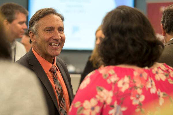 Fulton County Schools superintendent finalist Mike Looney (left) greets individuals after being announced Wednesday as the sole finalist for the job. The board will vote on his hiring May 2. (ALYSSA POINTER/ALYSSA.POINTER@AJC.COM)