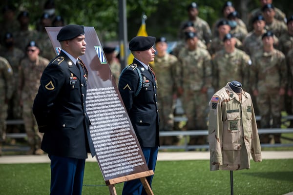 FORT STEWART, GA - MAY 20, 2021: Soldiers stand at attention during a ceremony honoring Sgt. 1st Class Alwyn Cashe. Cashe's unit, the 3rd Infantry Division, renamed its memorial garden after him. Cashe's uniform was displayed at the ceremony. (AJC Photo/Stephen B. Morton)