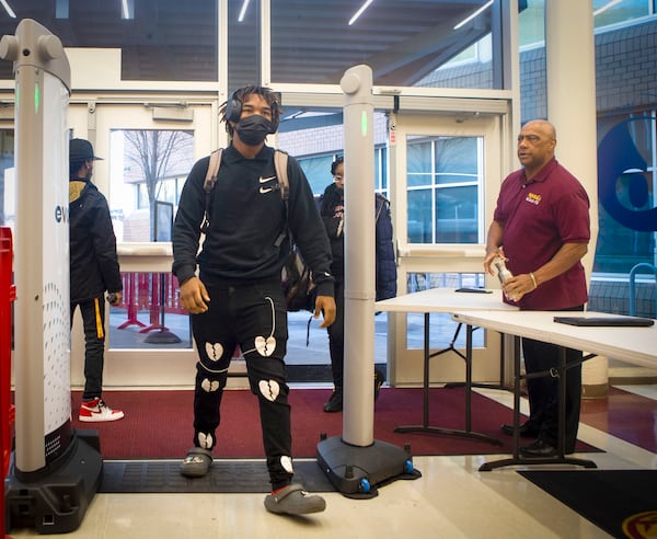 A student walks through security at Maynard Jackson High School in Atlanta on Tuesday, January 10, 2023. Atlanta Public Schools have implemented a new weapons detection system called "Evolv" in their middle and high schools. CHRISTINA MATACOTTA FOR THE ATLANTA JOURNAL-CONSTITUTION.