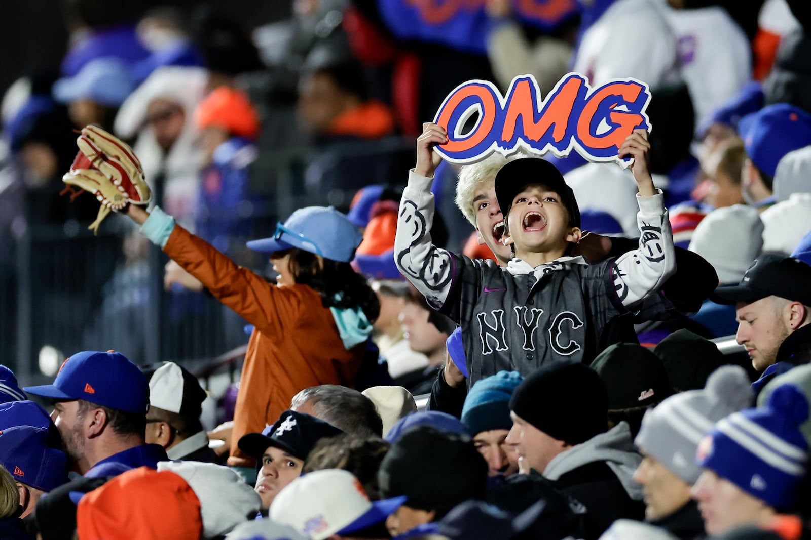 Fans cheer during the second inning in Game 3 of a baseball NL Championship Series between the Los Angeles Dodgers and the New York Mets, Wednesday, Oct. 16, 2024, in New York. (AP Photo/Adam Hunger)