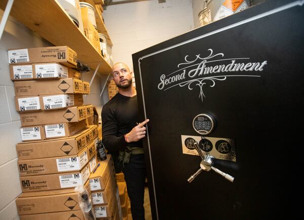 Benjamin Griggs sorts through a locked closet at the South Fulton Fire and Rescue Station on Cascade Road, where ammunition and projectiles are stored from floor to ceiling. 