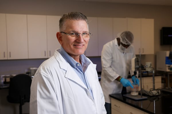 Chris Gerlach, CEO of Synergy Life Science, is shown in their laboratory, Wednesday, October 30, 2024, in Buford, Ga. Chris is an inventor that started his own company, Synergy Life Science. He has invented a derivative of CBD that he claims can be inhaled and absorbed more efficiently and safely than existing products. Also pictured is lab assistant Junior Hylton. (Jason Getz / AJC)

