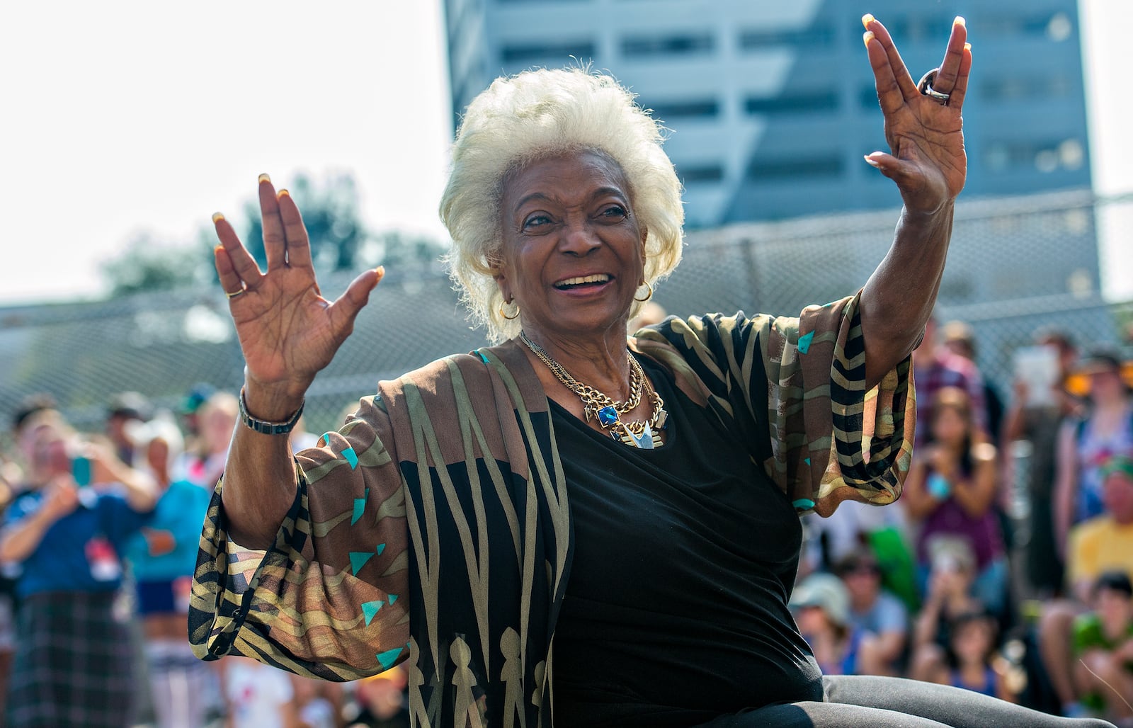 Nichelle Nichols, who played communications officer Lieutenant Uhura aboard the USS Enterprise in the popular Star Trek television series and succeeding motion pictures, gives the Vulcan symbol of live long and prosper as she rides down Peachtree St. during the annual DragonCon Parade in Atlanta on Saturday, September 5, 2015. JONATHAN PHILLIPS / SPECIAL