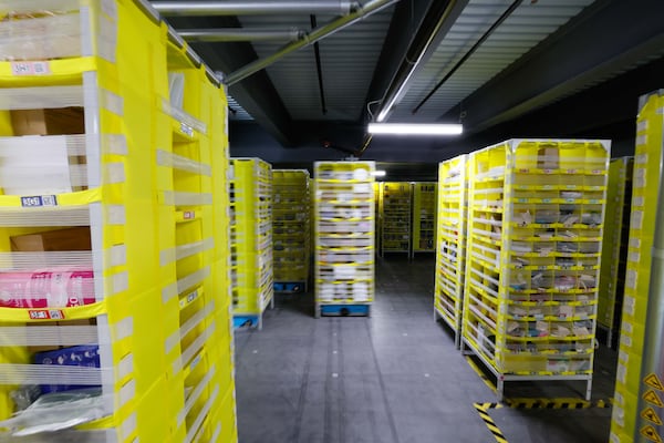 Dozens of yellow pods of items are moved by automated blue robots in the inventory section at the Amazon distribution Center in Stone Mountain on Monday, December 2, 2024, during one of the company’s busiest days, Cyber Monday.
(Miguel Martinez / AJC)