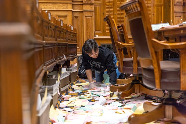 An employee of ICS Cleaners cleans the Senate after the legislative session in Atlanta on Sine Die, Wednesday, March 29, 2023. (Arvin Temkar /The Atlanta Journal-Constitution)