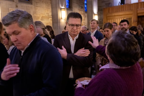 Parishioners take communion during an Ash Wednesday service inside the Cathedral of Christ the King in Atlanta on Wednesday, March 5, 2025. (Arvin Temkar/AJC)