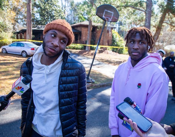 Bonner Ziglor (left) and his brother Bernard talk to the media in front of their grandmother's Decatur home where a fire claimed the lives of five of their family members. Their grandmother later died.