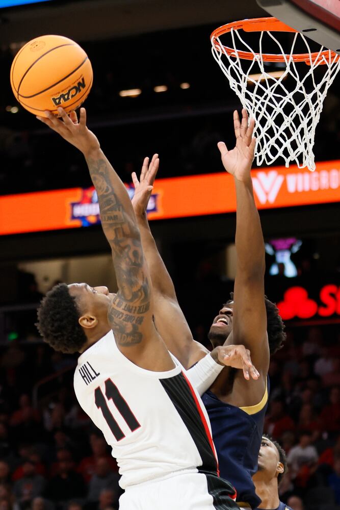 Bulldogs guard Justin Hill attempts a shot against Fighting Irish forward Ven-Allen Lubin during the first half Sunday night at State Farm Arena. (Miguel Martinez / miguel.martinezjimenez@ajc.com)