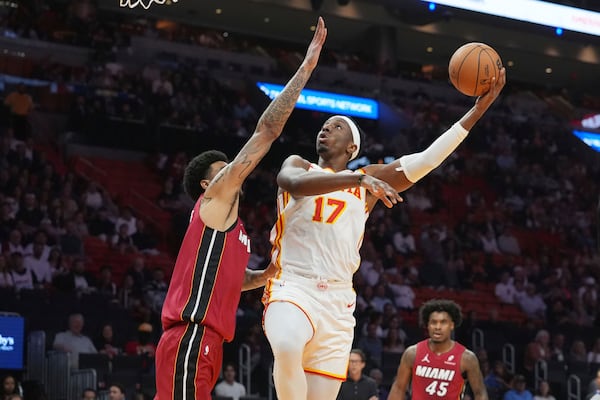 Atlanta Hawks forward Onyeka Okongwu (17) aims to score as Miami Heat center Kel'el Ware (7) defends during the first half of an NBA basketball game, Wednesday, Feb. 26, 2025, in Miami. (AP Photo/Marta Lavandier)