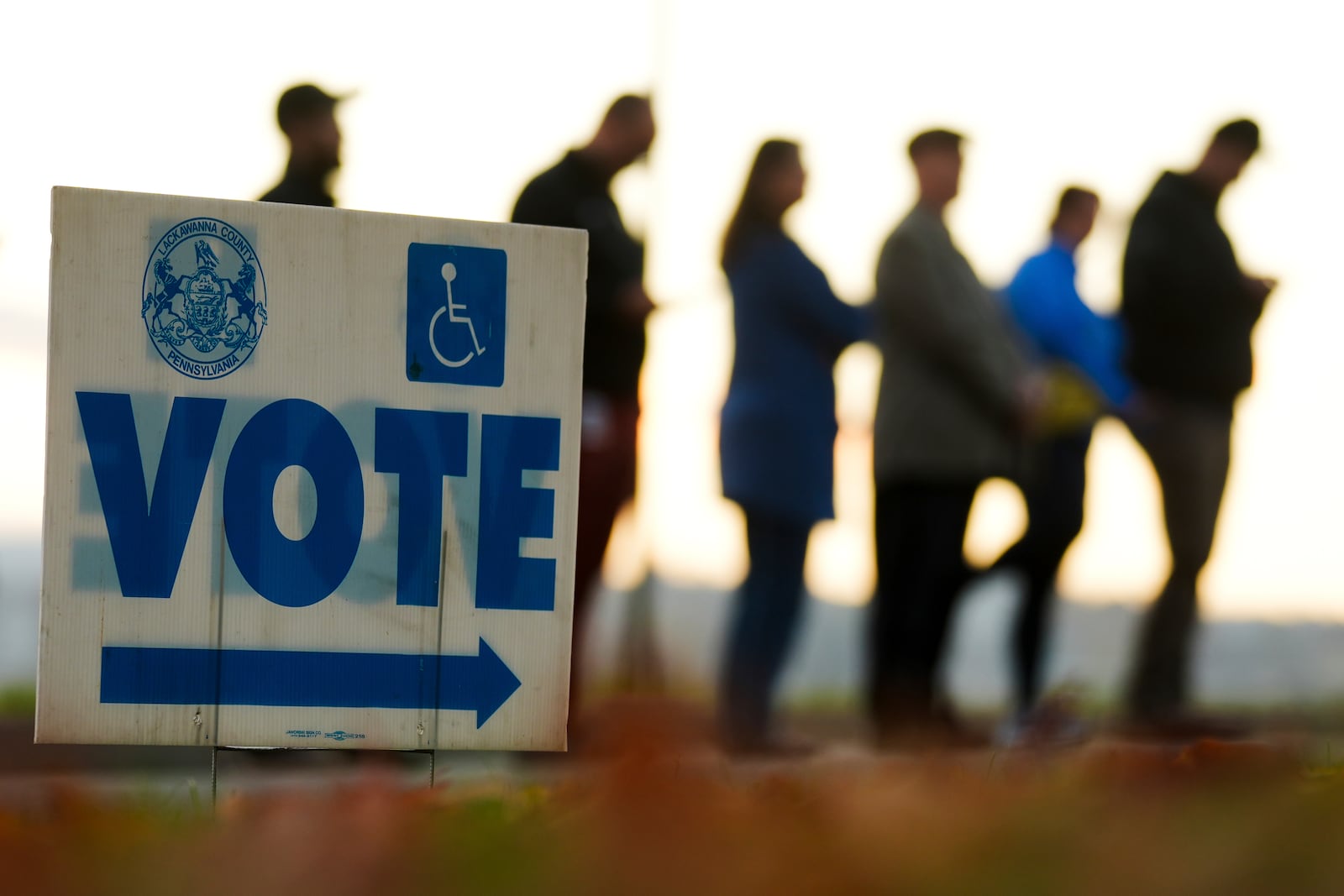 Voters wait in line to cast their ballots at Scranton High School in Scranton, Pa., on Election Day, Tuesday, Nov. 5, 2024. (AP Photo/Matt Rourke)