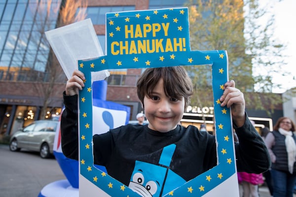 Framed by a dreidel shape, a boy gets into the spirit of Chanukah at the Avalon menorah lighting ceremony. (Courtesy)