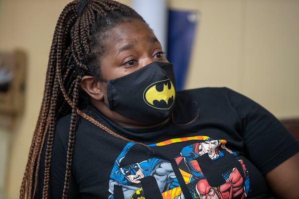 Yolander Brown, mother of Nigel Brown, cries while recounting her son’s playfulness. No solid evidence has surfaced yet that has led to an arrest, but she prays that day will come. “I’m begging for justice,” she says. (Alyssa Pointer/Atlanta Journal Constitution)