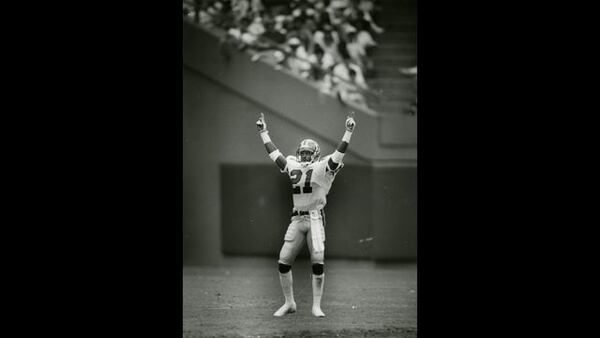 Deion Sanders gestures to the crowd before returning a punt for 68 yards for a touchdown in the first quarter of play against the Rams on Sept. 10, 1989