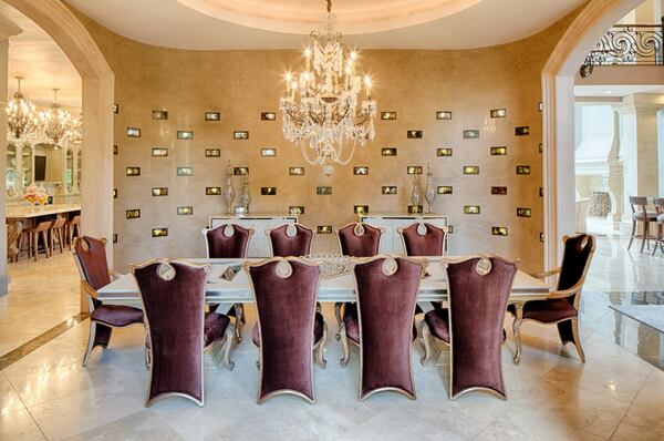 The dining room has a Venetian plaster wall installed with 97 tiger eye topaz glass lighting features backlit by LED lights.