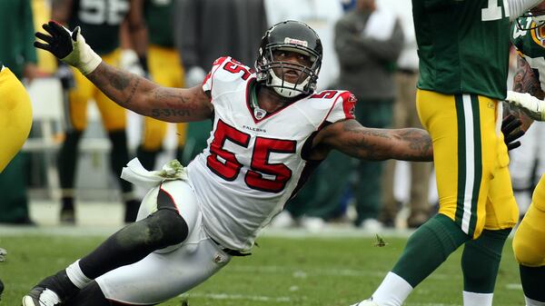 Falcons defensive end John Abraham comes in low with an all-out rush to tackle Packers quarterback Aaron Rodgers during second-half action on historic Lambeau Field, Sunday, Oct. 5, 2008. (Curtis Compton / AJC file)