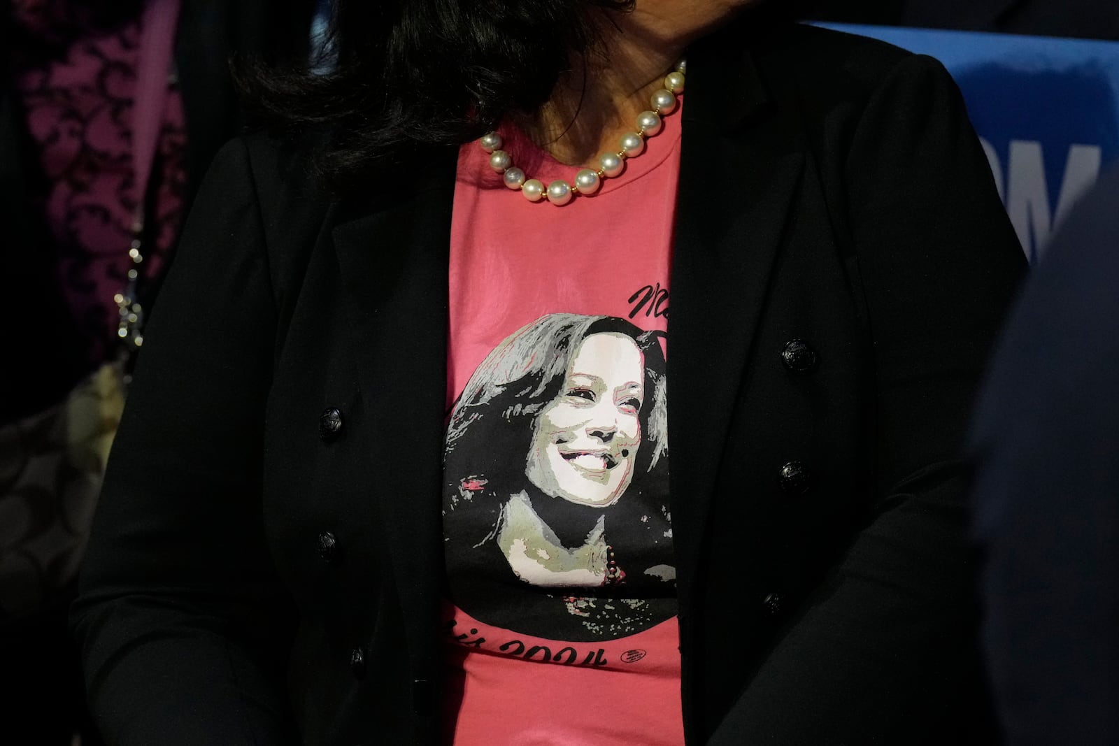 A supporter wearing a campaign-themed shirt sits in the audience at a campaign rally for Democratic presidential nominee Vice President Kamala Harris at Erie Insurance Arena, in Erie, Pa., Monday, Oct. 14, 2024. (AP Photo/Jacquelyn Martin)