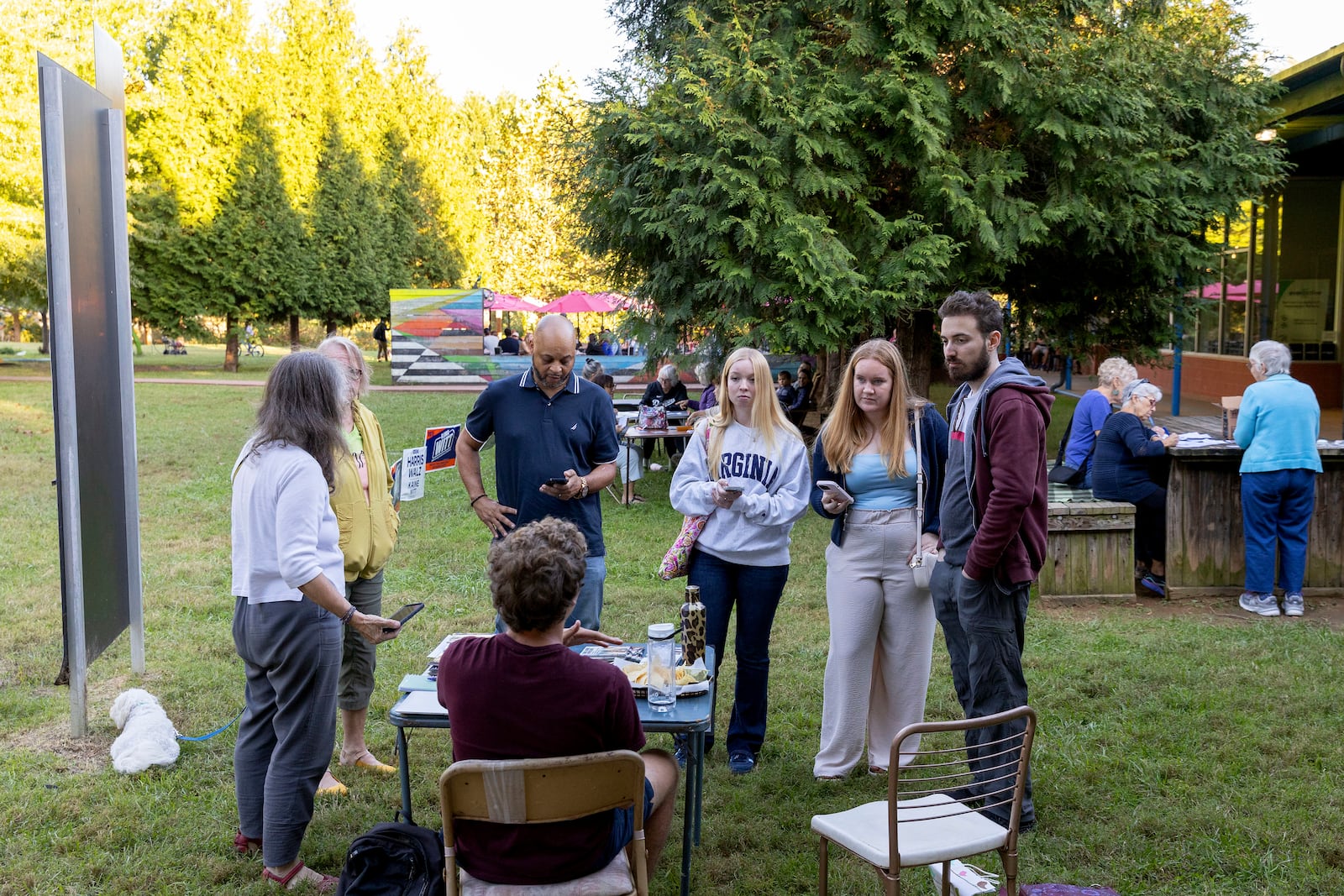 Volunteers receive canvassing instructions at IX Art Park in Charlottesville, Va., Thursday, Oct. 10, 2024. Charlottesville Democrats meet weekly to make phone calls, write postcards and send texts to get out the vote. (AP Photo/Ryan M. Kelly)