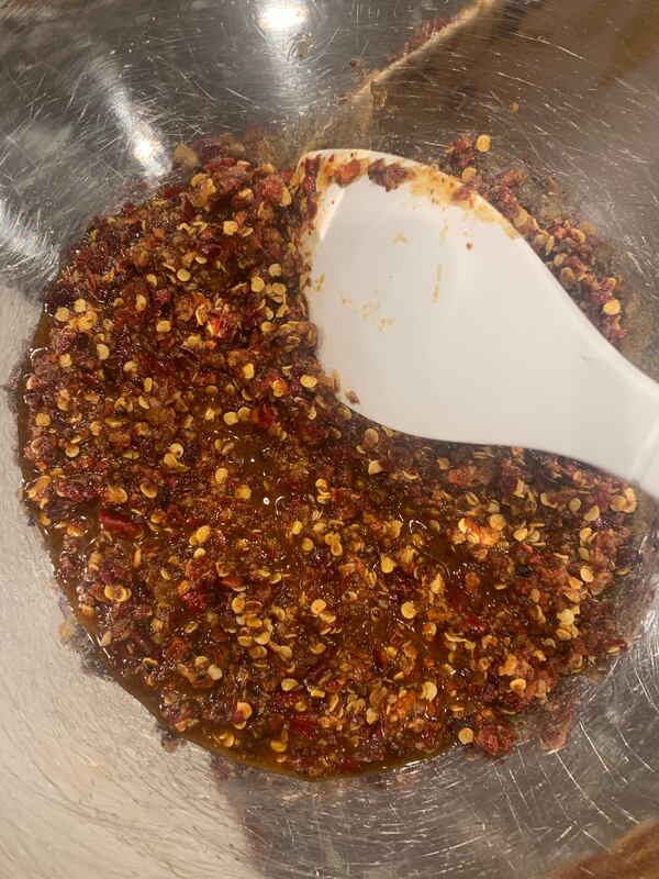 Here, Spicy Chili Crisp is being prepared. John Kessler for The AJC