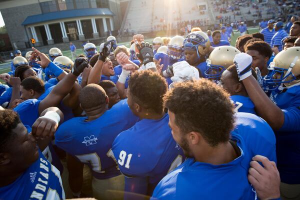 McEachern huddles during warmups prior to the game against Buford at Walter H. Cantrell Stadium in Powder Springs, Ga. on Friday, Sept. 4, 2015. (Kevin Liles/AJC)