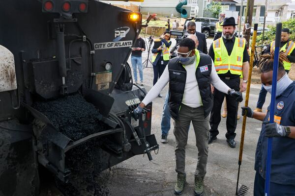 ATLDOT Commissioner Josh Rowan (at right) joined Mayor Dickens and the "pothole posse" ahead of Mayor Dickens' 100th day in office in Atlanta on Monday, April 11, 2022. (Bob Andres / robert.andres@ajc.com)