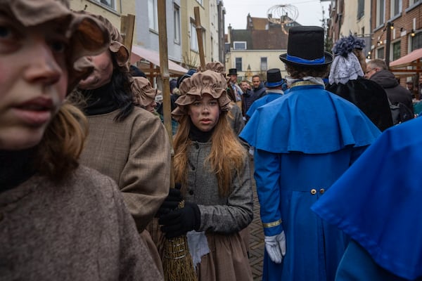 People in costumes from Charles Dickens' 19th-century English take part in a Dickens Festival, in Deventer, Netherlands, Saturday, Dec. 14, 2024. (AP Photo/Peter Dejong)