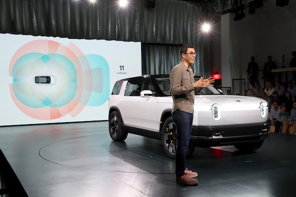 Founder and CEO of Rivian RJ Scaringe speaks onstage during the Rivian Reveals All-Electric R2 Midsize SUV event at Rivian South Coast Theater on March 7, 2024, in Laguna Beach, Calif. (Phillip Faraone/Getty Images for Rivian)