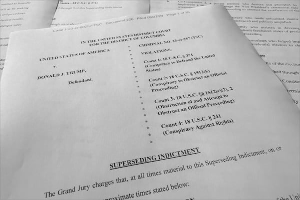 FILE - The superseding indictment against former President Donald Trump is photographed Tuesday, Aug. 27, 2024, after special counsel Jack Smith filed the new indictment against Trump that keeps the same criminal charges but narrows the allegations against him following a Supreme Court opinion conferring broad immunity on former presidents. (AP Photo/Jon Elswick, File)