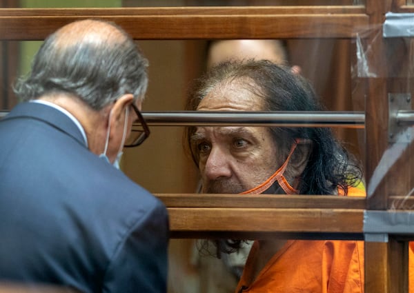 Adult film star Ron Jeremy talks with his attorney Stuart Goldfarb during his arraignment Friday. Jeremy pleaded not guilty to the charges.